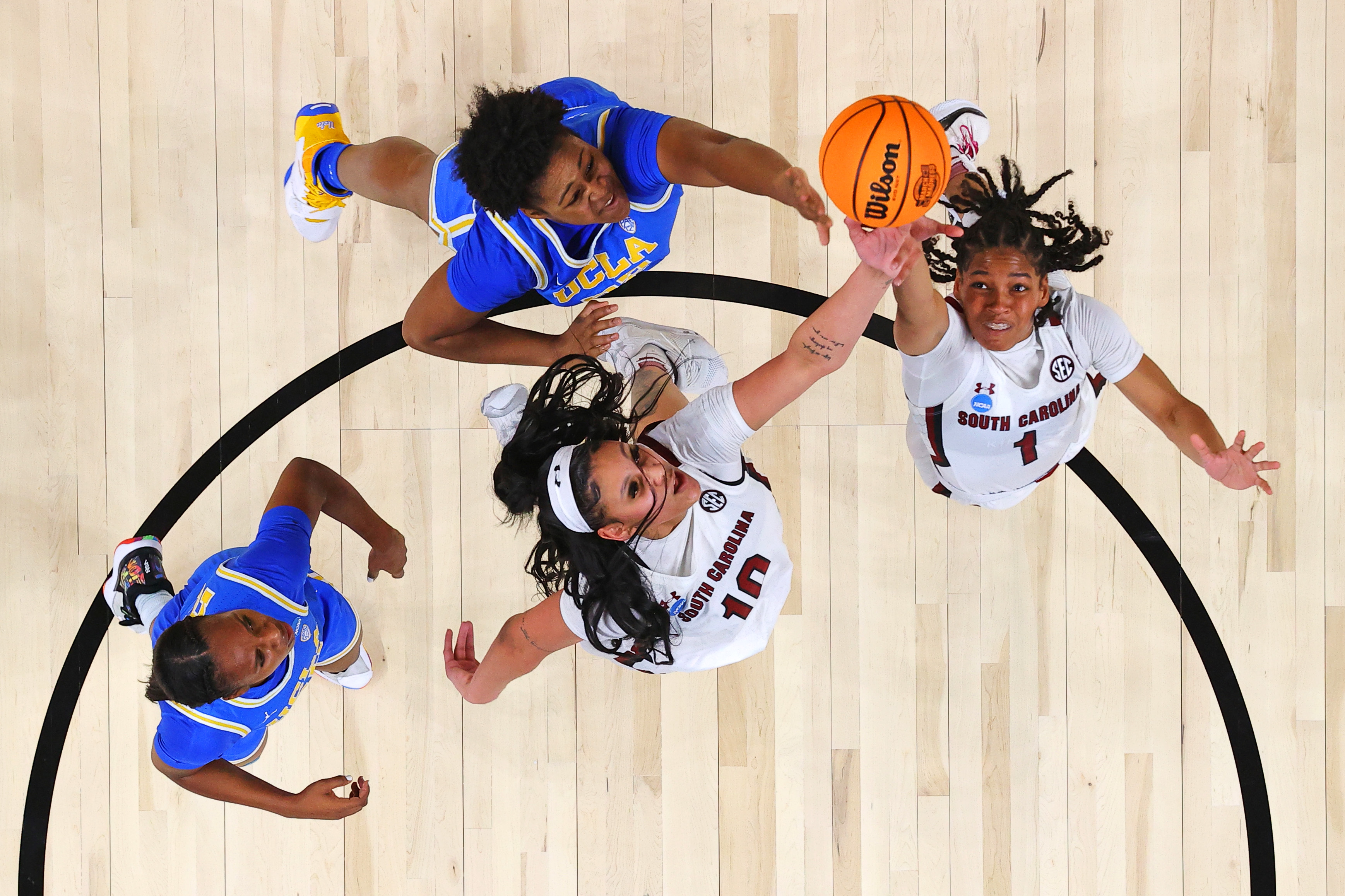  Kamilla Cardoso #10 of the South Carolina Gamecocks and Zia Cooke #1 of the South Carolina Gamecocks go for a rebound against Charisma Osborne #20 of the UCLA Bruins and Christeen Iwuala #22 of the UCLA Bruins in the Sweet 16 round of the NCAA Women's Basketball Tournament 