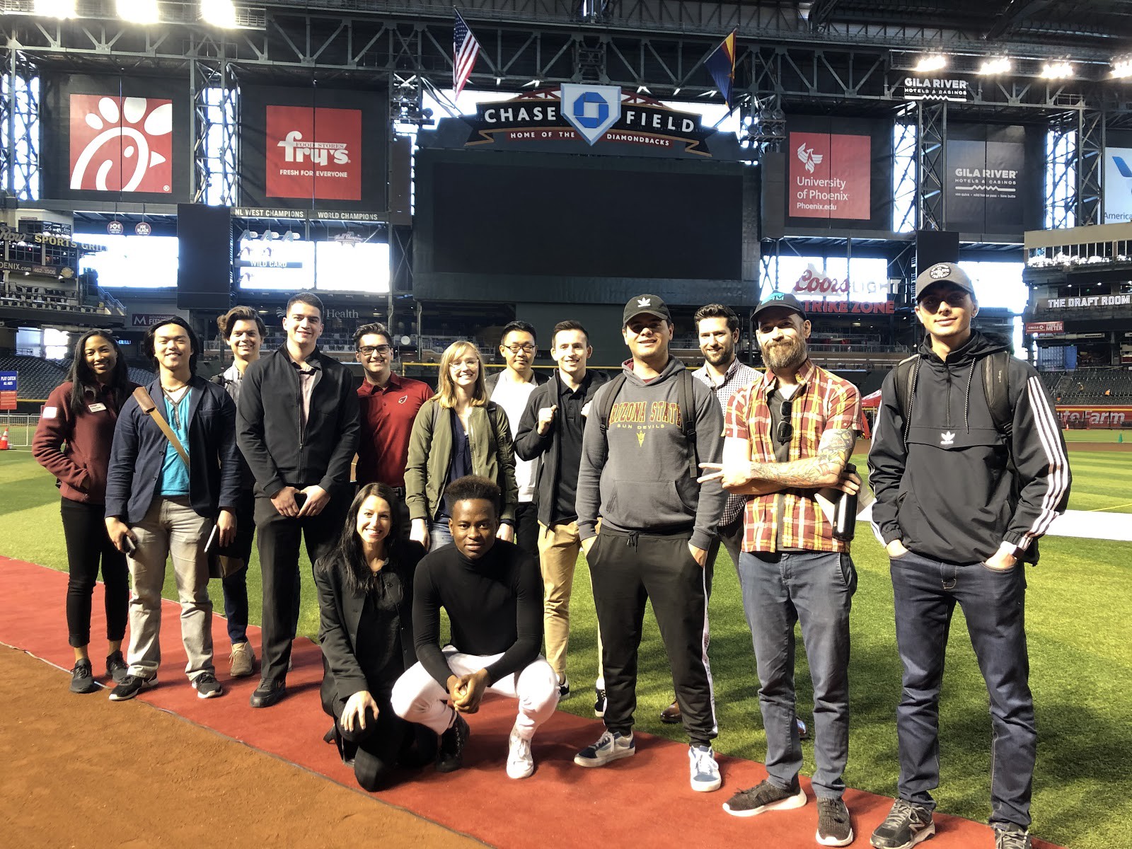 Students on the tour posing for a photo on the field at Chase Field, home of the Arizona Diamondbacks