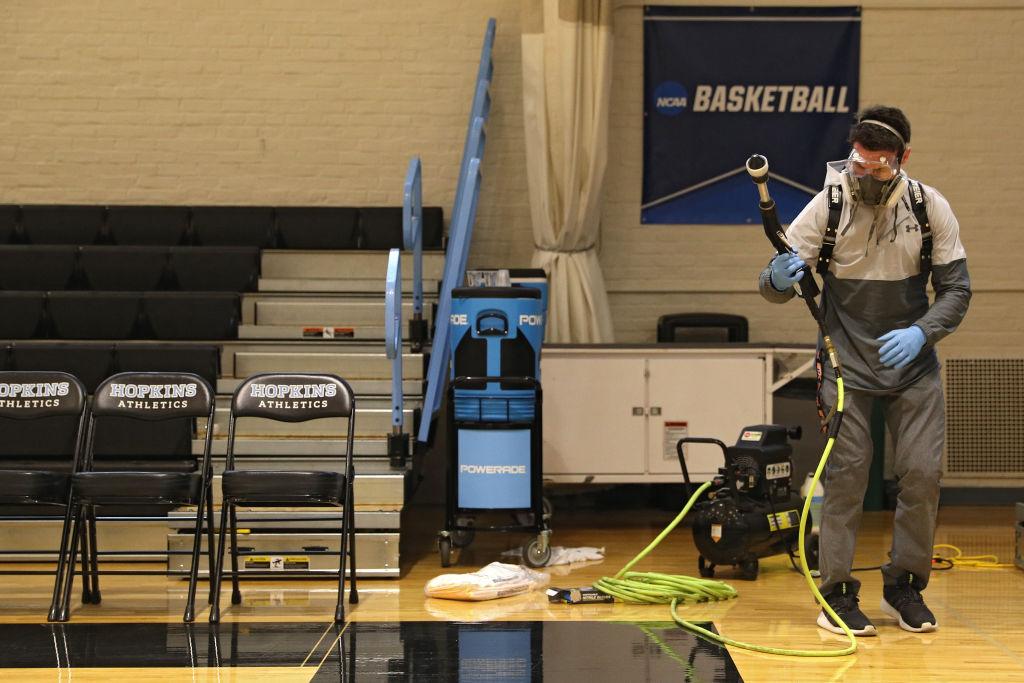 Taylor Michel, Director of Operations of DTG, Disinfecting Technologies Group, prepares to disinfect the arena following Yeshiva playing Worcester Polytechnic Institute in the NCAA Division III Men's Basketball Championship - First Round at Goldfarb Gymna