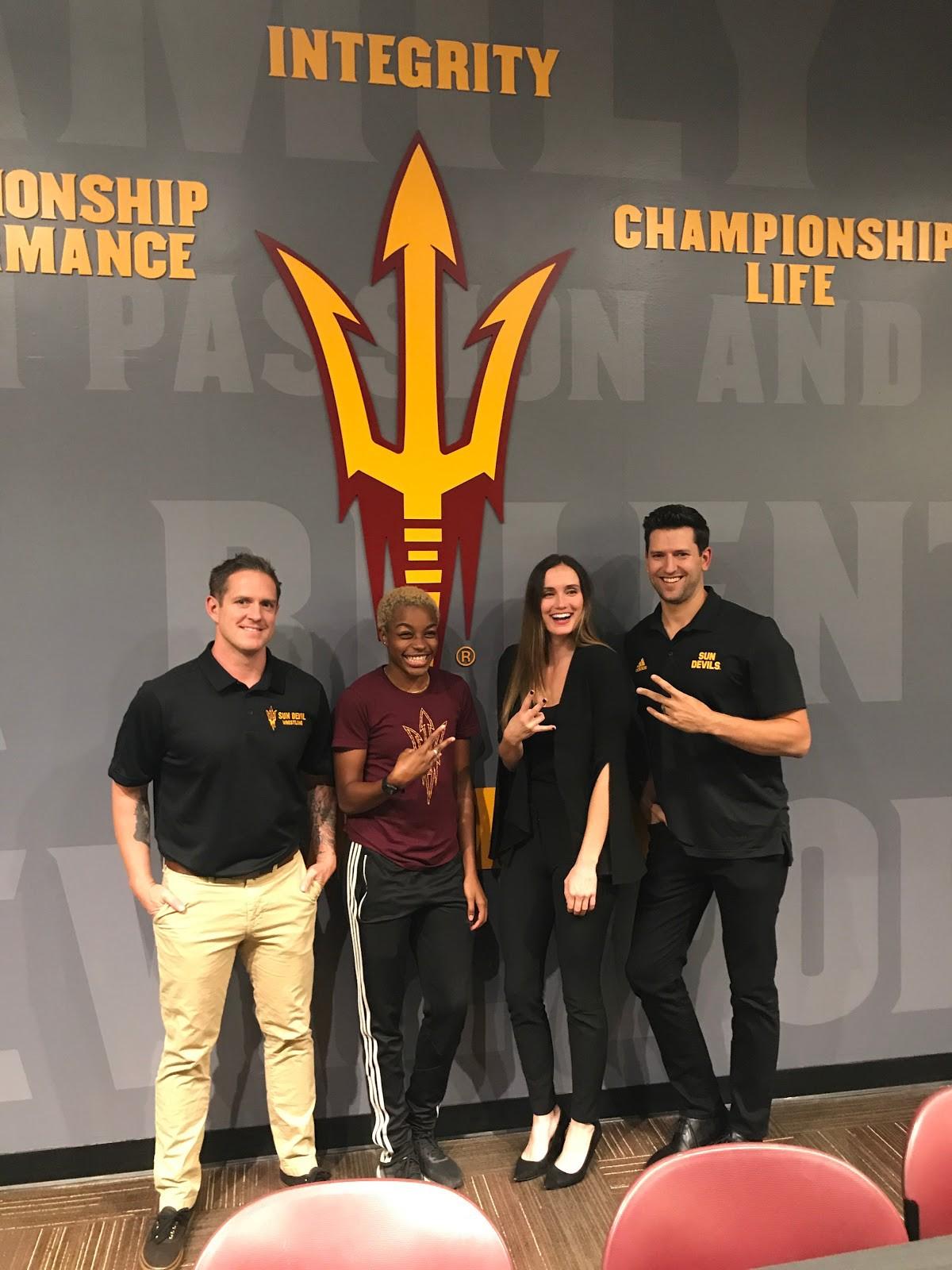 Roman Rozell, Jeminise Parris, Brittany Martin, and Jeff Kunowski posing with sun devil forks up