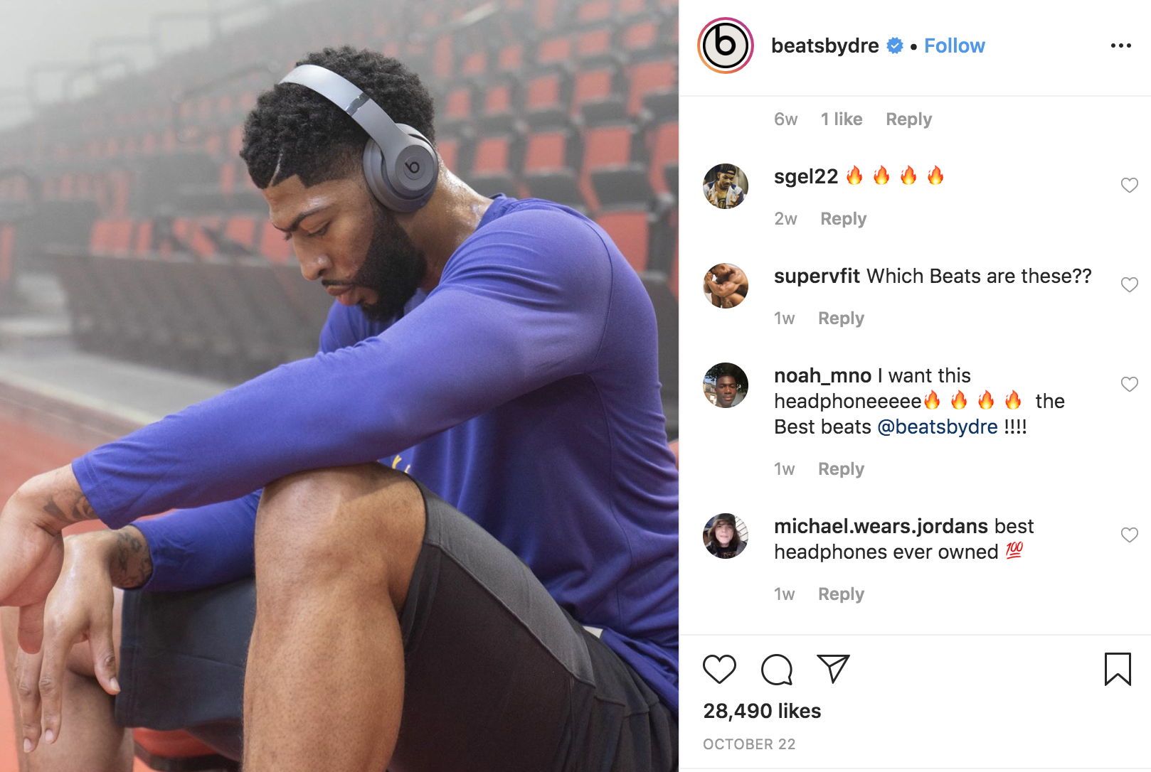 NBA player Anthony Davis sits on the sidelines of court after practice with Beats by Dre headphones on.